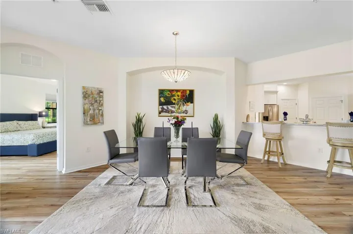 Dining area with light wood-style floors and baseboards