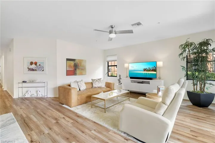 Living room with light wood-style floors and a ceiling fan