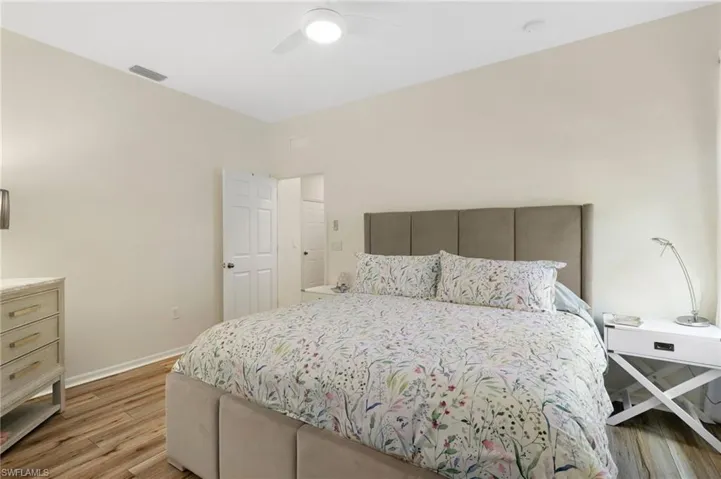 Bedroom with light wood-style flooring and a ceiling fan