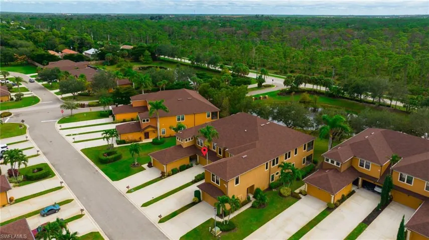 Aerial view of residential area featuring a forest