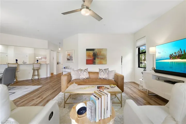 Living area with wood finished floors and a ceiling fan