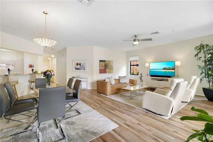 Dining space with light wood-style flooring and ceiling fan