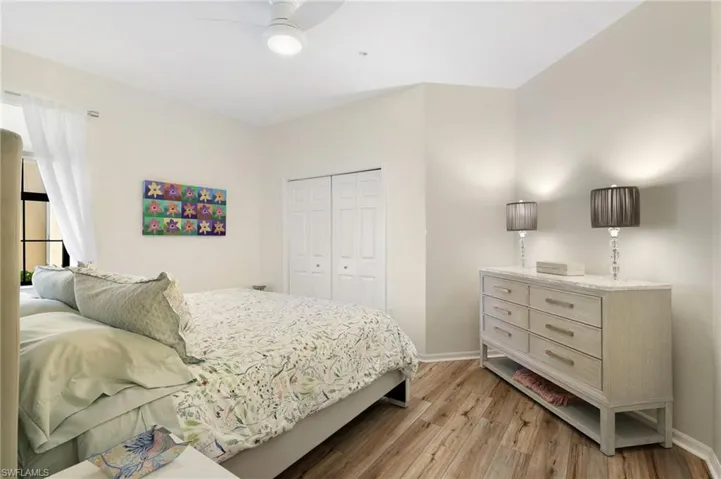 Bedroom with light wood-type flooring, a closet, and ceiling fan