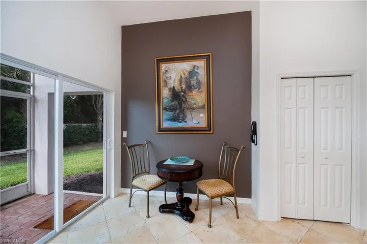 Sitting room with a healthy amount of sunlight and baseboards