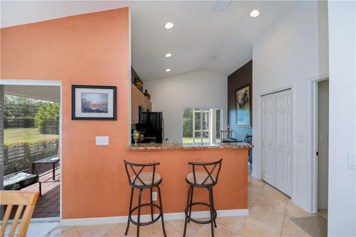 Kitchen with black appliances, a healthy amount of sunlight, visible vents, and recessed lighting