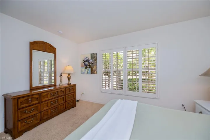 Bedroom featuring baseboards and light colored carpet