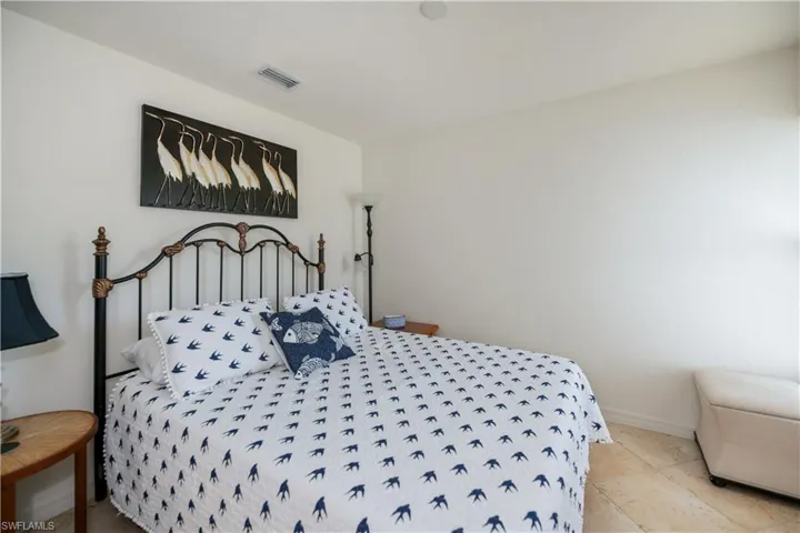 Bedroom featuring baseboards and visible vents