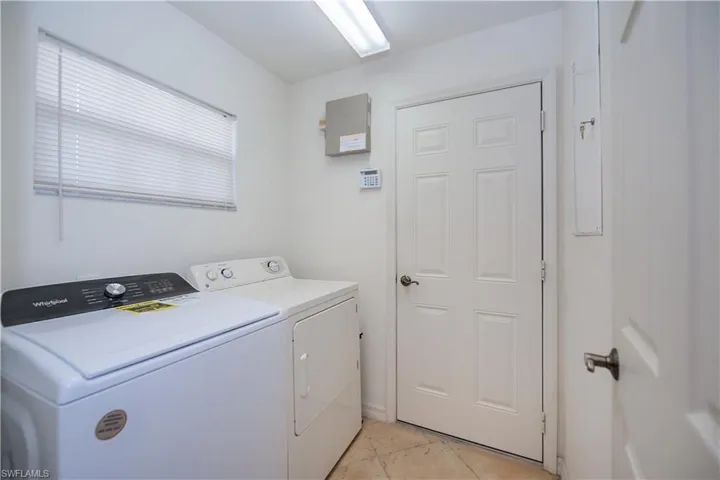 Laundry room featuring washing machine and clothes dryer and laundry area