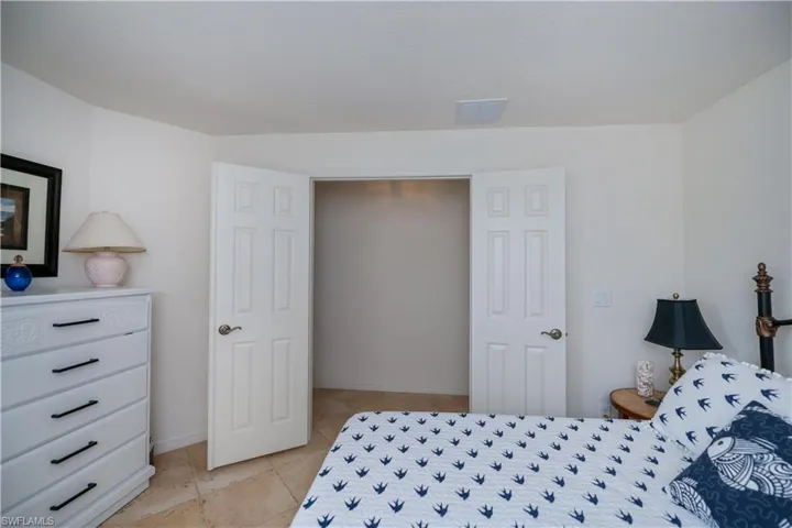 Bedroom with baseboards and light tile patterned flooring