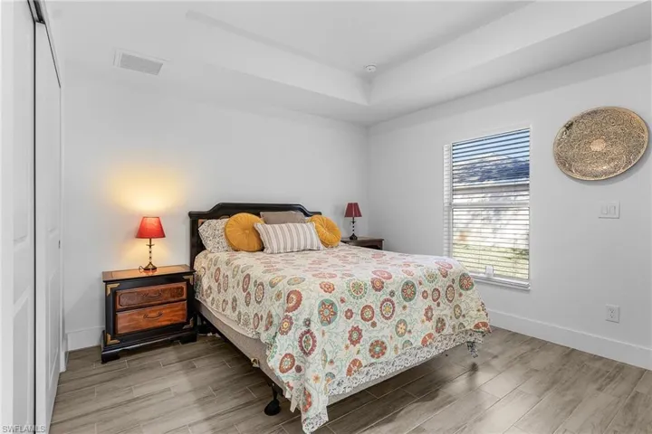 Bedroom with a tray ceiling and a closet