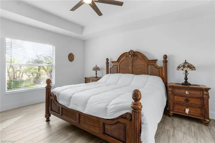 Bedroom with ceiling fan and light hardwood / wood-style floors
