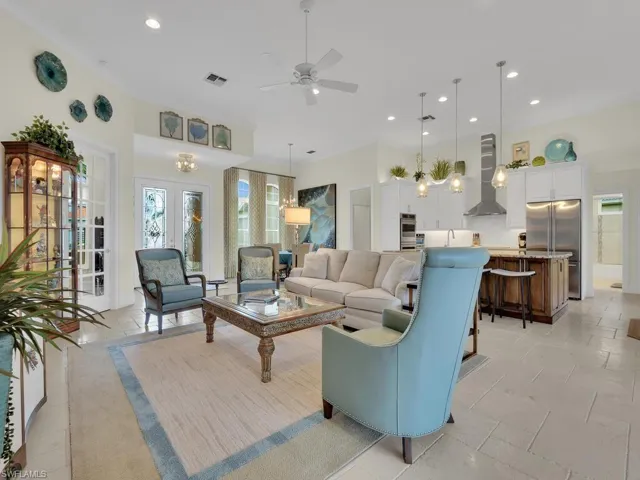 Living room featuring ceiling fan, recessed lighting, and french doors