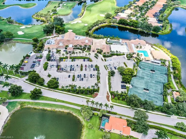 View of property location with a golf club and a large body of water