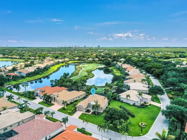 Aerial perspective of suburban area featuring a nearby body of water