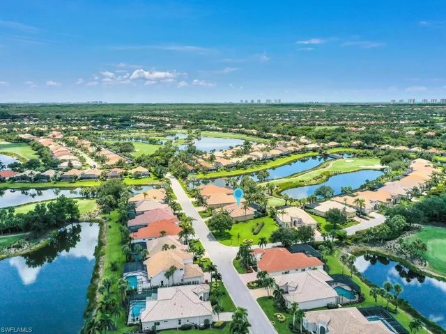 View of property location featuring nearby suburban area, a large body of water, and a golf club
