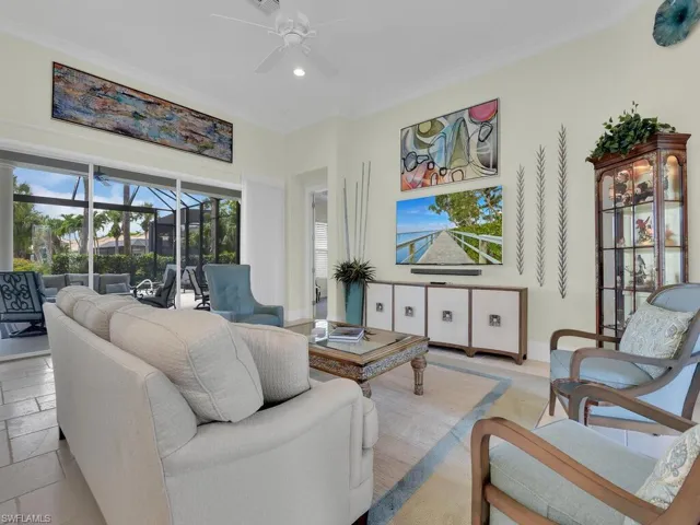 Living room with ceiling fan, a sunroom, and recessed lighting