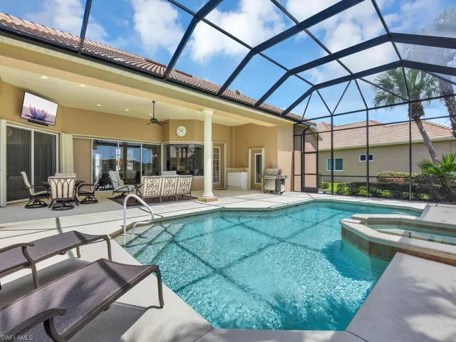 View of pool with a patio, a ceiling fan, a pool with connected hot tub, and a lanai