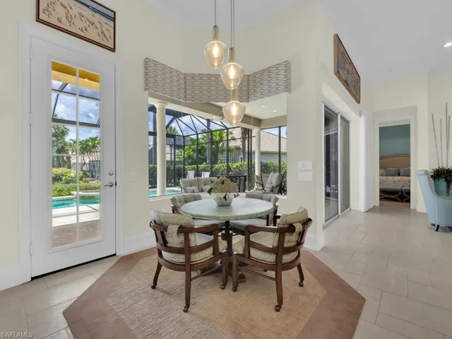 Dining space with a sunroom and stone tile flooring