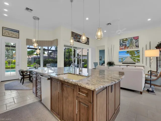 Kitchen featuring recessed lighting, light stone countertops, dishwasher, ceiling fan, and healthy amount of natural light