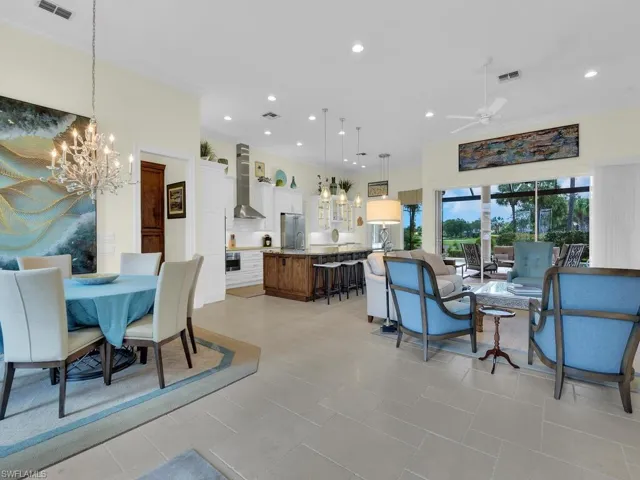 Dining space featuring a chandelier, a ceiling fan, and recessed lighting