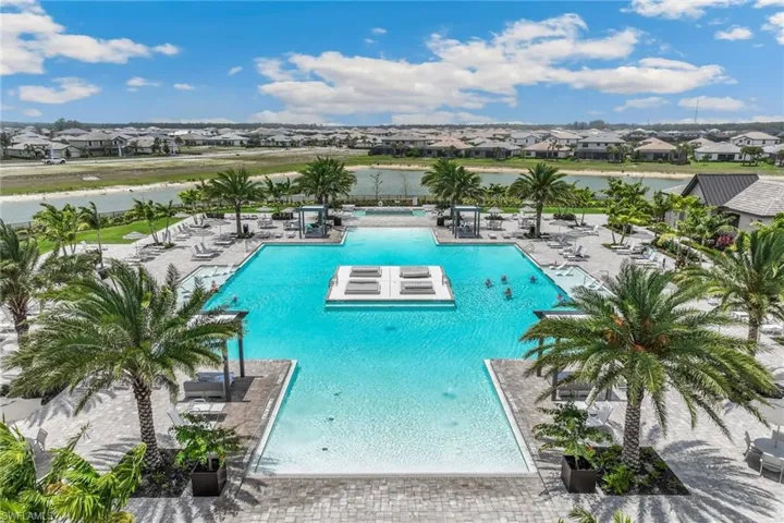 Pool featuring a residential view, a patio, and a jacuzzi