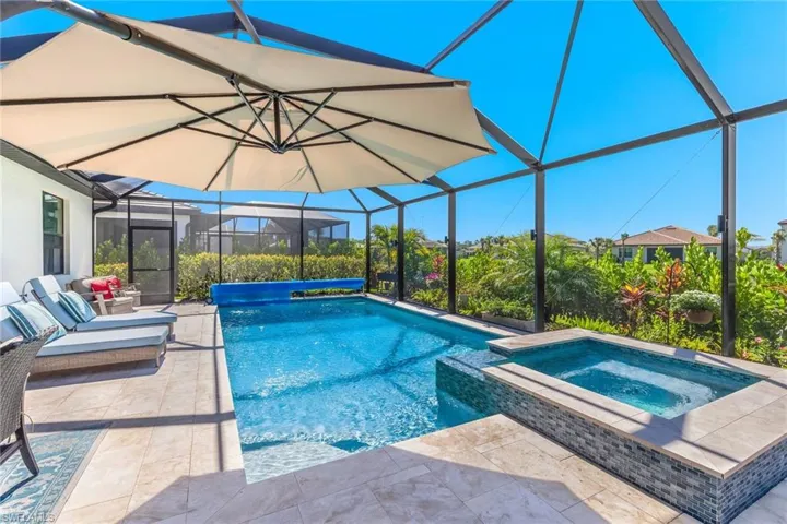 View of swimming pool featuring a lanai, a patio, and a pool with connected hot tub