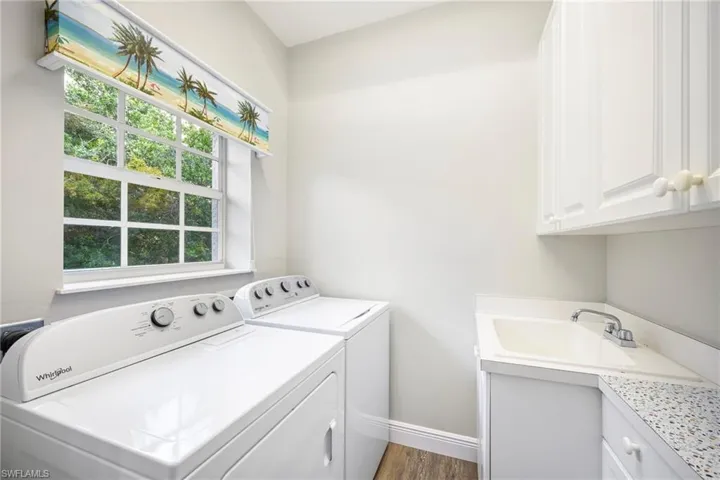 Laundry area with cabinets and sink