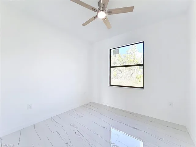 Spare room with a ceiling fan and light wood-style floors