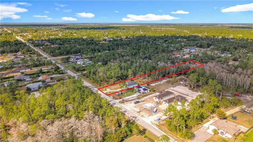 Aerial view of property's location featuring property boundaries highlighted and a forest