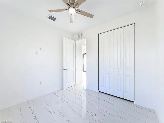 Unfurnished bedroom featuring a closet and ceiling fan