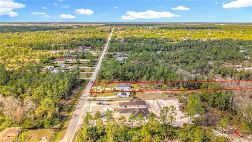 Aerial overview of property's location featuring property parcel outlined and a forest