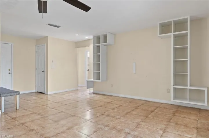 Tiled spare room with ceiling fan
