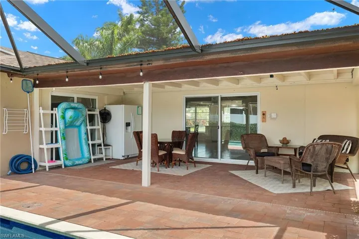 Back of house with a lanai and a patio area