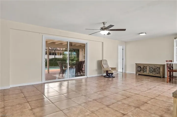 Unfurnished room with light tile patterned floors and ceiling fan