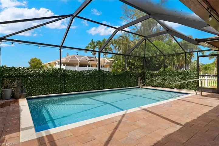 View of pool with a patio and a lanai