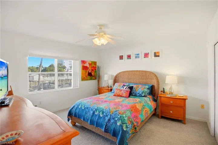 The primary bedroom enjoys an en-suite bath, walk-in closet and slider out to the screened lanai.