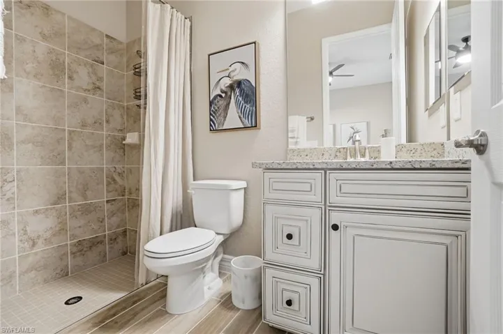 Bathroom featuring a stall shower and vanity