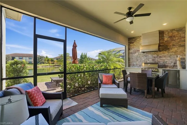 Sunroom / solarium featuring a water view