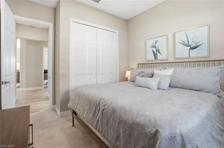 Bedroom featuring a closet and light carpet