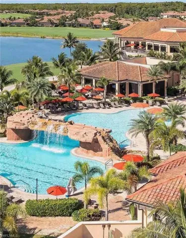 Community pool with a patio and a water view