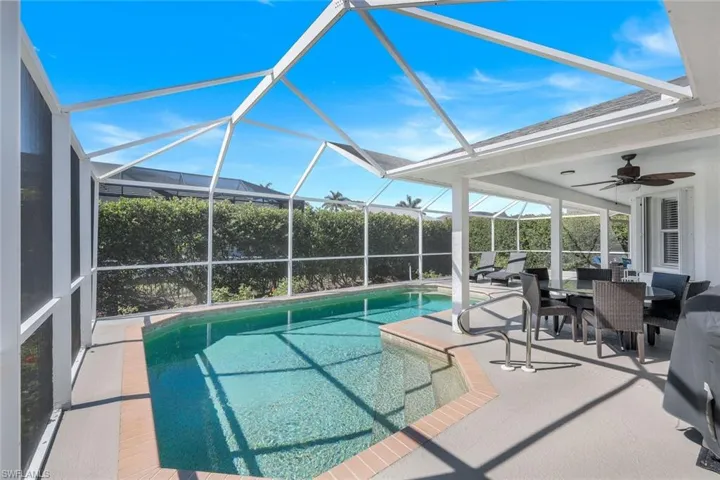 View of swimming pool featuring ceiling fan, a lanai, and a patio area