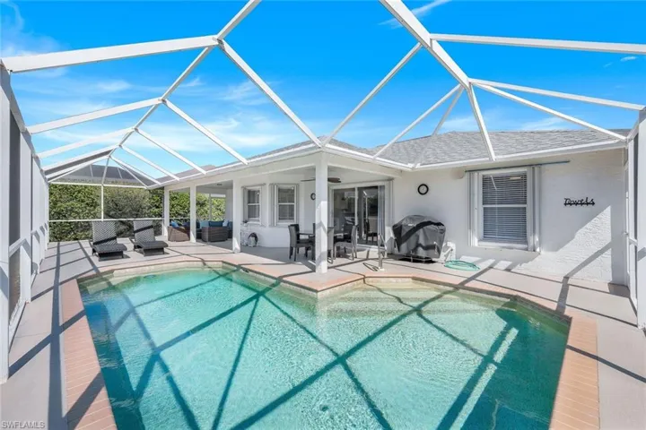 View of swimming pool with an outdoor hangout area, a patio area, ceiling fan, and glass enclosure
