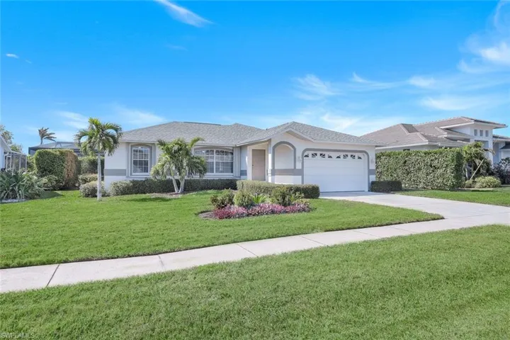 Ranch-style home with a garage and a front yard