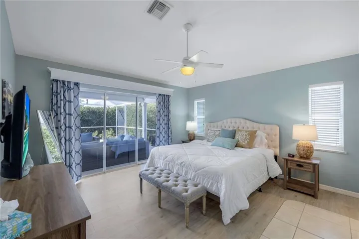 Bedroom featuring ceiling fan, light wood-type flooring, and access to outside