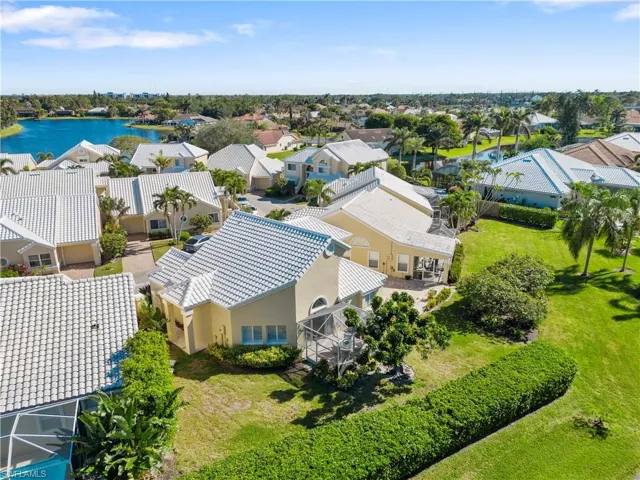 Birds eye view of property with a water view