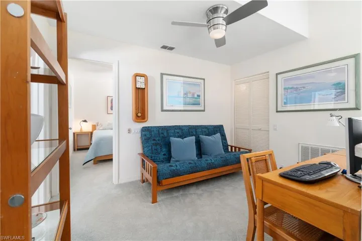 Living area featuring ceiling fan and light carpet