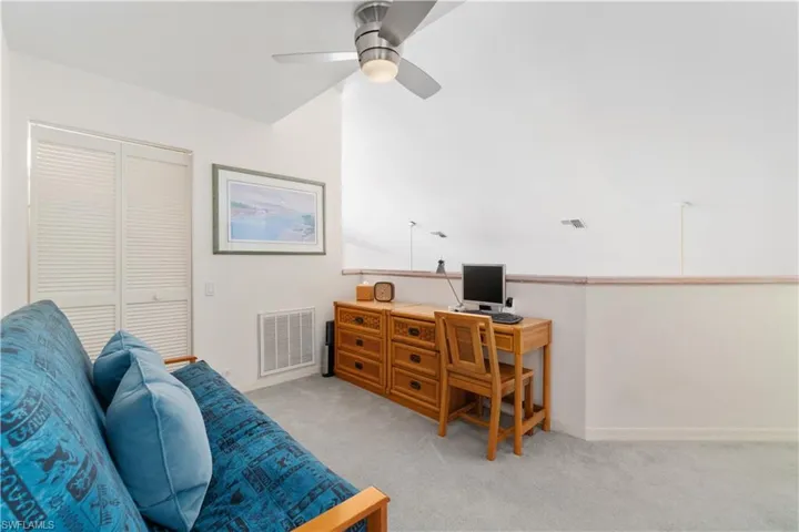 Carpeted office space with ceiling fan