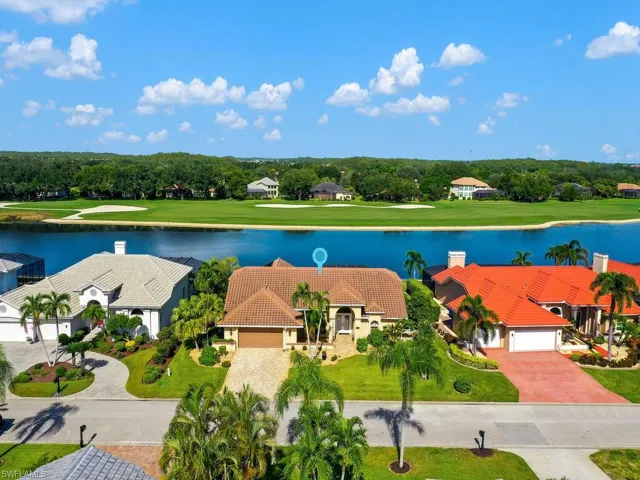 Aerial view of residential area with a golf club and a nearby body of water