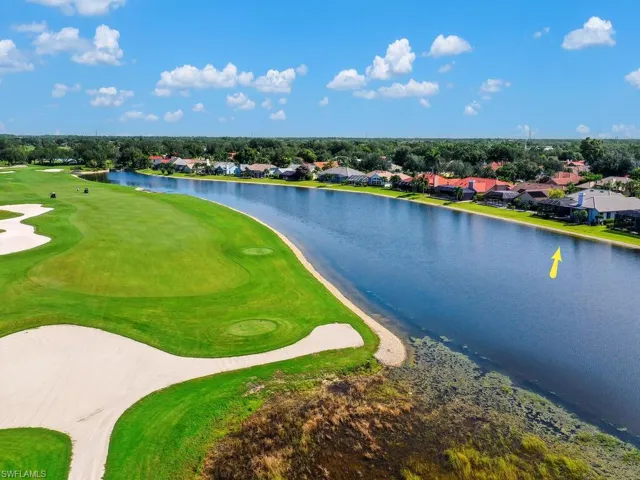Aerial view of residential area with a large body of water and a golf club