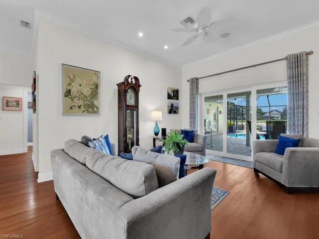 Living area featuring crown molding, wood finished floors, recessed lighting, and ceiling fan